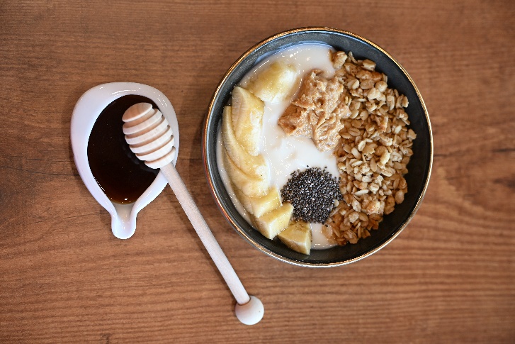 Granola and yogurt breakfast bowl with honey
