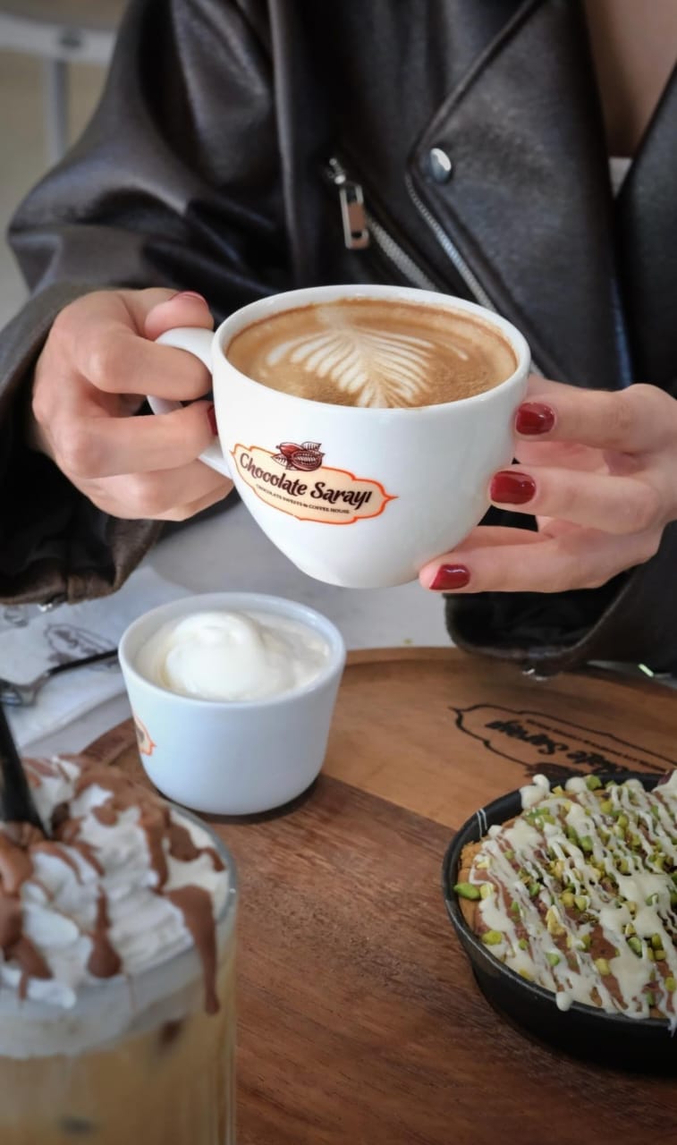 Cappuccino with latte art in a Chocolate Sarayı cup